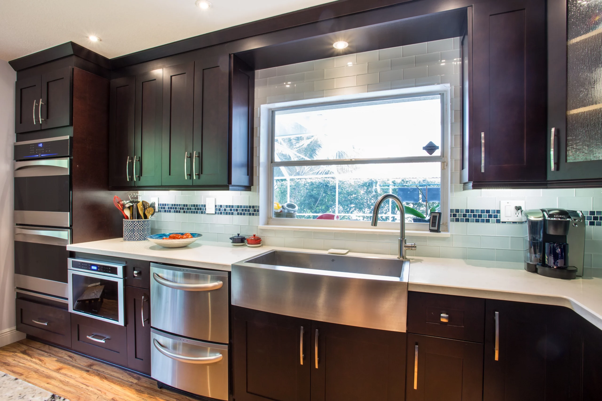 Dark wood cabinets and stainless steel appliances in a contemporary kitchen remodeling project.