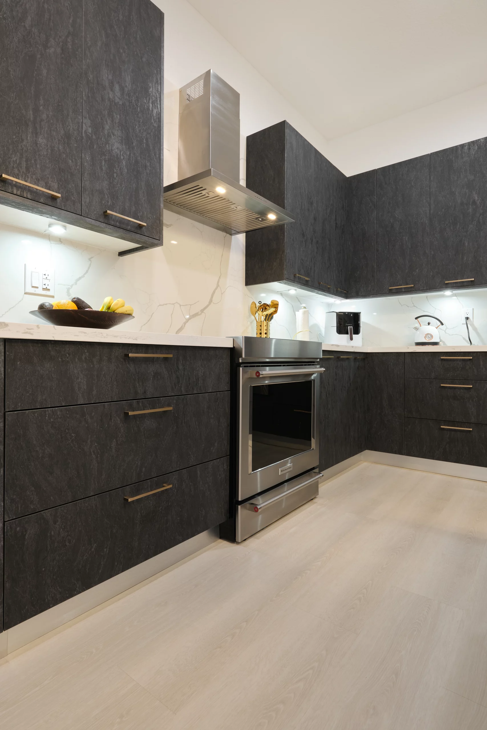 kitchen-remodeling-dark-textured-cabinets-stainless-oven