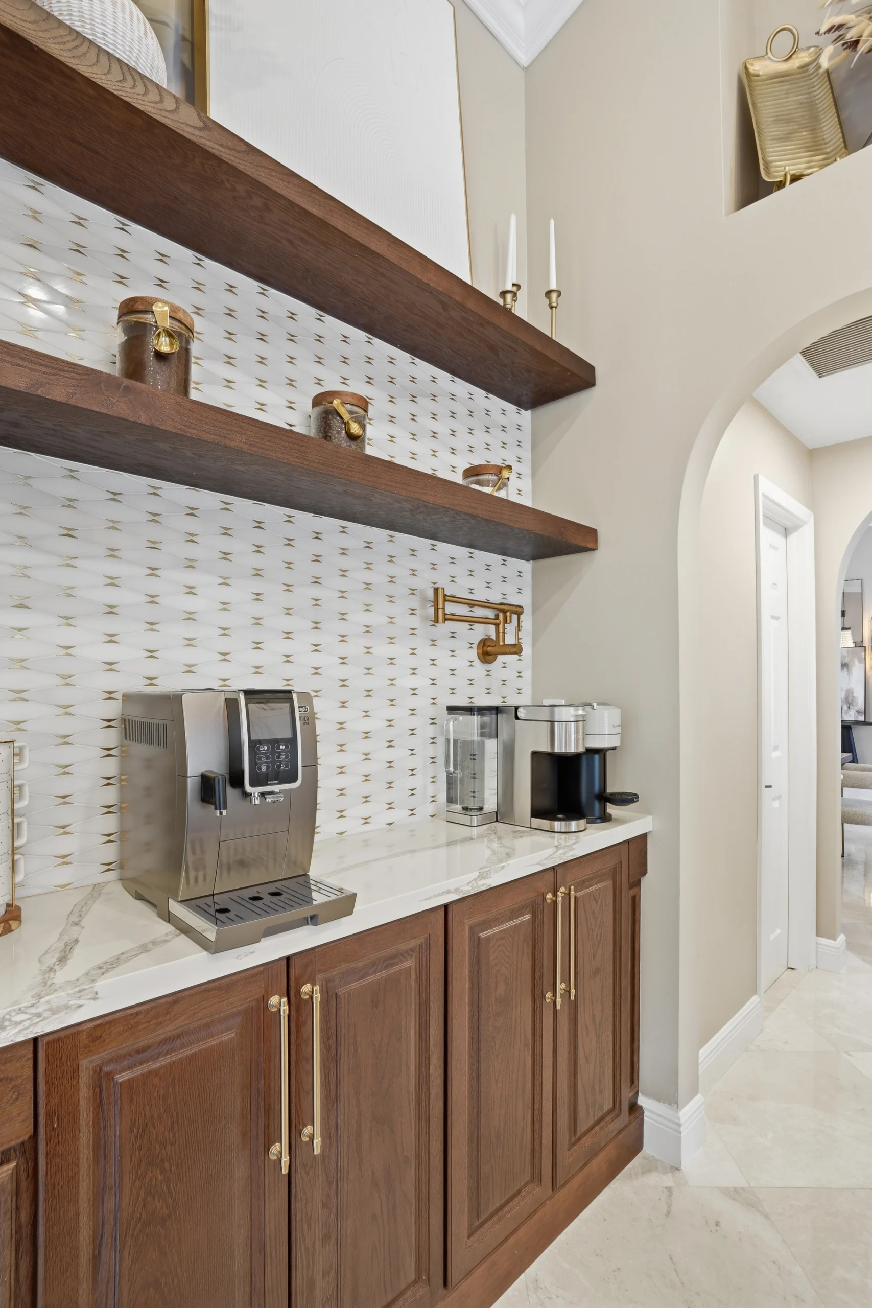 Custom wet bar with dark wood cabinetry and marble countertop in a luxury kitchen renovation in Plantation, Florida.